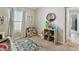 Inviting ' bedroom featuring a window with curtains and a toy storage area at 13027 Pennybrook Dr, Riverview, FL 33579