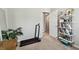 Cozy bedroom featuring a treadmill and decorative shelving, providing fitness and style at 13027 Pennybrook Dr, Riverview, FL 33579