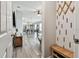 Inviting entryway with wood-look flooring, decorative wall accents, and a glimpse into the open living spaces at 13027 Pennybrook Dr, Riverview, FL 33579