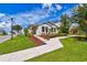 Well-maintained home with manicured lawn, tidy mulch beds, and a welcoming walkway to the front door at 13027 Pennybrook Dr, Riverview, FL 33579