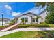 Charming single-story home with well-manicured landscaping, stone walkway, and inviting curb appeal at 13027 Pennybrook Dr, Riverview, FL 33579