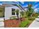Well-maintained home with manicured lawn, tidy mulch beds, and a welcoming walkway to the front door at 13027 Pennybrook Dr, Riverview, FL 33579