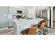 Open-concept kitchen with bar seating at the island, stainless steel appliances, and shaker style cabinets at 13027 Pennybrook Dr, Riverview, FL 33579