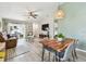 Open-concept living room and dining area with wood-look floors, comfortable seating, and modern decor at 13027 Pennybrook Dr, Riverview, FL 33579