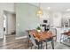 Open-concept living area showcasing a dining table, kitchen and geometric accent wall at 13027 Pennybrook Dr, Riverview, FL 33579