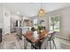 Bright open-concept living space that connects the kitchen, dining and living area; wood-look flooring throughout at 13027 Pennybrook Dr, Riverview, FL 33579