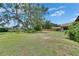 Expansive backyard with mature trees and a wooden fence, offering privacy and a park-like setting at 1309 Sandalwood Dr, Plant City, FL 33563