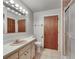 Bathroom with a tiled shower, vanity, and neutral wall paint at 1309 Sandalwood Dr, Plant City, FL 33563