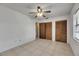Bedroom featuring closets, tiled floors, and a ceiling fan at 1309 Sandalwood Dr, Plant City, FL 33563