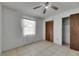 Bedroom featuring a ceiling fan, window, and closet at 1309 Sandalwood Dr, Plant City, FL 33563