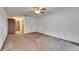 Spacious bedroom featuring neutral carpeting and a ceiling fan with ample natural light at 1309 Sandalwood Dr, Plant City, FL 33563