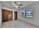 Bedroom featuring a window, closet, ceiling fan, and tiled flooring at 1309 Sandalwood Dr, Plant City, FL 33563