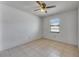 Bedroom featuring a ceiling fan, window, and tiled flooring at 1309 Sandalwood Dr, Plant City, FL 33563
