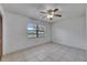Bedroom featuring a window, ceiling fan, and tiled flooring at 1309 Sandalwood Dr, Plant City, FL 33563
