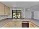 Kitchen has a garden view window, neutral countertops, cabinets and a dishwasher at 1309 Sandalwood Dr, Plant City, FL 33563