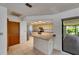 Kitchen with tile floors, neutral countertops, and view to screened in porch at 1309 Sandalwood Dr, Plant City, FL 33563