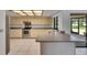 Kitchen with tile flooring, appliances, countertops, cabinets, and access to the lanai at 1309 Sandalwood Dr, Plant City, FL 33563