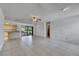 Open-plan living room with view to kitchen and patio at 1309 Sandalwood Dr, Plant City, FL 33563