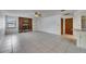 Open-concept living room featuring stone fireplace and tiled floors at 1309 Sandalwood Dr, Plant City, FL 33563