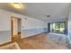 Open-concept living room with access to outdoor space through sliding glass doors and adjacent doorways at 1309 Sandalwood Dr, Plant City, FL 33563