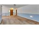 Expansive living room featuring blue and white walls, neutral carpeting, and natural light at 1309 Sandalwood Dr, Plant City, FL 33563