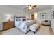 Comfortable main bedroom with a king bed, ceiling fan, and sitting area at 1309 Sandalwood Dr, Plant City, FL 33563