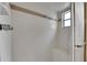 Shower with white tile, shower head, seat, grab bar and framed window for natural light at 1309 Sandalwood Dr, Plant City, FL 33563