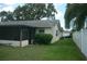 Cozy home backyard with a screened-in porch and privacy fence, perfect for relaxing or entertaining outdoors at 13627 San Rafael Dr, Largo, FL 33774