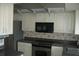 This kitchen features white cabinetry, stainless steel appliances and dark countertops at 13627 San Rafael Dr, Largo, FL 33774