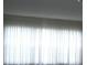 A view of a bright living room with sheer curtains and natural light at 13627 San Rafael Dr, Largo, FL 33774