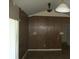 This living room features wood paneling, tile floors, and sliding glass doors at 13627 San Rafael Dr, Largo, FL 33774