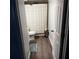 Small, functional bathroom features wood-look floors and a neutral shower curtain at 14219 Shadow Moss Ln # 102, Tampa, FL 33613