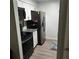 Efficient kitchen featuring white cabinets and stainless steel appliances at 14219 Shadow Moss Ln # 102, Tampa, FL 33613