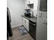 Modern kitchen featuring white cabinets, stainless steel appliances, and granite countertops at 14219 Shadow Moss Ln # 102, Tampa, FL 33613