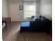 Inviting living room with hardwood floors and a comfortable blue sofa at 14219 Shadow Moss Ln # 102, Tampa, FL 33613