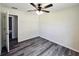 This bedroom features gray wood floors and a ceiling fan with light at 1557 S Martin Luther King Jr Ave, Clearwater, FL 33756