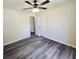 Bedroom featuring gray wood-look floors, a ceiling fan and adjacent closet in a renovated home at 1557 S Martin Luther King Jr Ave, Clearwater, FL 33756