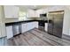 Bright kitchen featuring modern stainless steel appliances, white cabinets, and dark countertops at 1557 S Martin Luther King Jr Ave, Clearwater, FL 33756