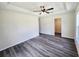 Main bedroom featuring a ceiling fan, tray ceiling, and walk-in closet in a renovated home at 1557 S Martin Luther King Jr Ave, Clearwater, FL 33756