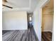 Main bedroom featuring a ceiling fan, tray ceiling, and walk-in closet in a renovated home at 1557 S Martin Luther King Jr Ave, Clearwater, FL 33756