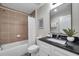 Updated bathroom features a shower-tub combo, granite counters, and stylish fixtures at 1561 S Martin Luther King Jr Ave, Clearwater, FL 33756