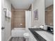Bathroom showcasing a shower-tub combo, granite counters, and decorative wall tiles at 1561 S Martin Luther King Jr Ave, Clearwater, FL 33756