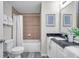 Well-lit bathroom featuring a shower-over-tub, modern fixtures, and neutral-toned tiling at 1561 S Martin Luther King Jr Ave, Clearwater, FL 33756