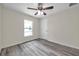This bedroom is bright with a window and features gray, wood-look flooring at 1561 S Martin Luther King Jr Ave, Clearwater, FL 33756