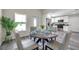 Dining area featuring a modern table and chairs with natural light and kitchen view at 1561 S Martin Luther King Jr Ave, Clearwater, FL 33756