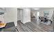 Dining Room and Living Room area featuring new gray wood-look flooring and neutral decor at 1561 S Martin Luther King Jr Ave, Clearwater, FL 33756