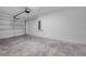 Clean two-car garage featuring modern garage door, garage door opener, and concrete flooring at 1561 S Martin Luther King Jr Ave, Clearwater, FL 33756