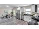 This kitchen features stainless steel appliances, granite countertops and gray wood-look flooring at 1561 S Martin Luther King Jr Ave, Clearwater, FL 33756