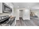 Modern kitchen flows into the living area, featuring new appliances and gray wood-look flooring at 1561 S Martin Luther King Jr Ave, Clearwater, FL 33756
