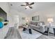 Bright living room featuring a comfortable gray sectional, ceiling fan, and new floors at 1561 S Martin Luther King Jr Ave, Clearwater, FL 33756